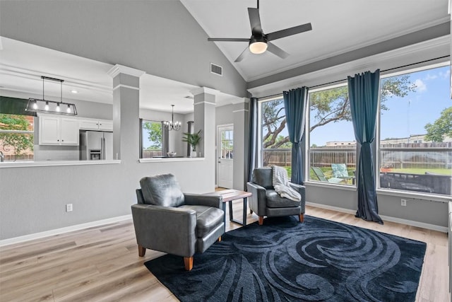 120 Spring Ct, Georgetown, TX 78633 - living area with light wood-style floors, a chandelier, a ceiling fan, baseboards, and vaulted ceiling