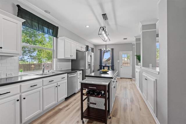 120 Spring Ct, Georgetown, TX 78633 - kitchen with stainless steel appliances, a sink, decorative backsplash, white cabinetry, and recessed lighting
