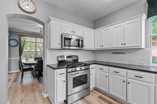 120 Spring Ct, Georgetown, TX 78633 - kitchen with appliances with stainless steel finishes, dark countertops, white cabinets, and light wood-style flooring