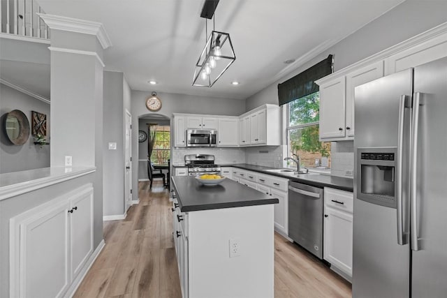 120 Spring Ct, Georgetown, TX 78633 - kitchen featuring stainless steel appliances, a sink, dark countertops, ornamental molding, and tasteful backsplash