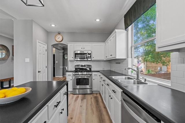 120 Spring Ct, Georgetown, TX 78633 - kitchen with stainless steel appliances, a sink, dark countertops, white cabinets, and recessed lighting