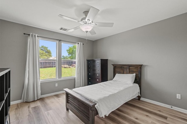 120 Spring Ct, Georgetown, TX 78633 - bedroom with baseboards, light wood-type flooring, and a ceiling fan