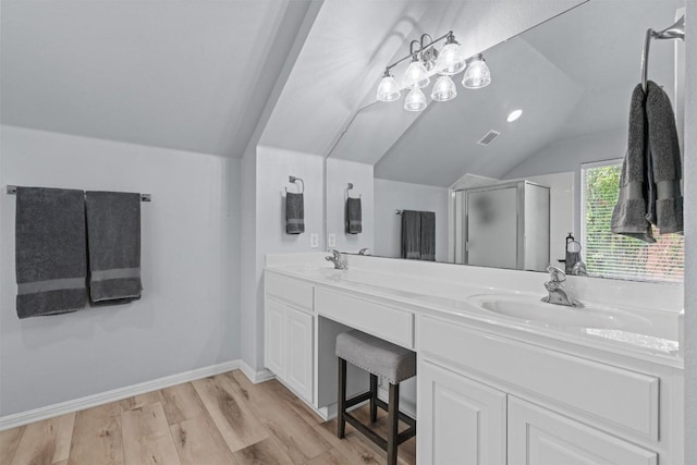 120 Spring Ct, Georgetown, TX 78633 - full bathroom featuring vaulted ceiling, a stall shower, double vanity, wood finished floors, and baseboards