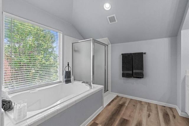 120 Spring Ct, Georgetown, TX 78633 - bathroom featuring lofted ceiling, a shower stall, a bath, wood finished floors, and baseboards