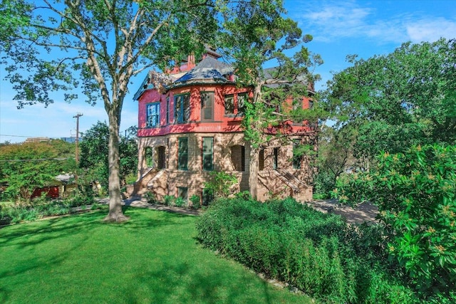back of property with a lawn and a chimney
