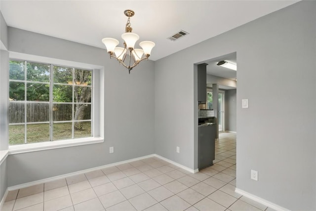 902 Valley Glen Cv, Pflugerville, TX 78660 - unfurnished room featuring a chandelier, light tile patterned floors, and baseboards