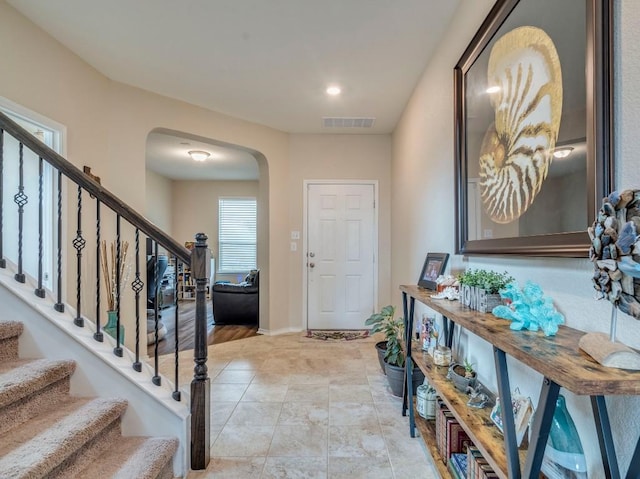 270 Fuchsia St, Kyle, TX 78640 - entryway featuring arched walkways, stairway, and baseboards