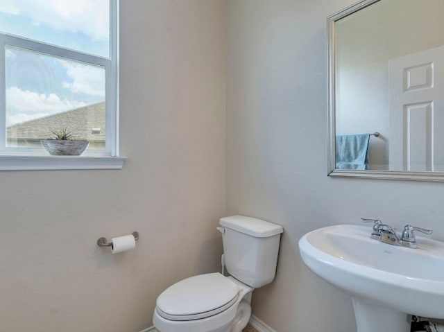 270 Fuchsia St, Kyle, TX 78640 - half bath featuring toilet, baseboards, and a sink