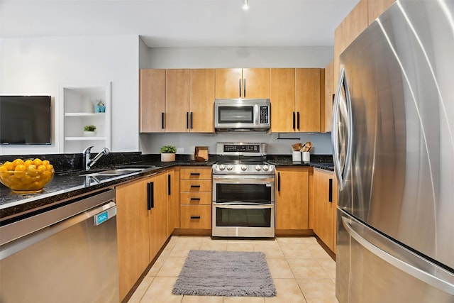 54 Rainey St Unit 815, Austin, TX 78701 - kitchen with appliances with stainless steel finishes, a sink, dark stone countertops, and light tile patterned floors