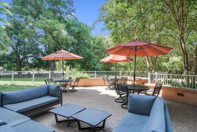 54 Rainey St Unit 617, Austin, TX 78701 - fenced backyard with outdoor dining space, outdoor lounge area, a patio area, and view of scattered trees