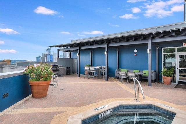 54 Rainey St Unit 617, Austin, TX 78701 - view of swimming pool featuring a hot tub, a patio, outdoor dining area, and exterior kitchen