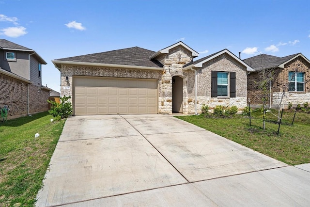 204 Connor Ln, Georgetown, TX 78626 - view of front of house with driveway, a garage, a front yard, and stone siding