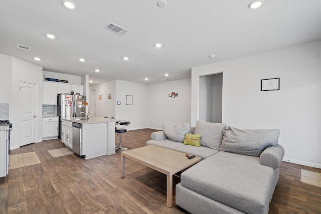 204 Connor Ln, Georgetown, TX 78626 - living area with dark wood-type flooring, recessed lighting, and baseboards