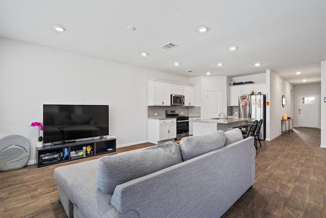 204 Connor Ln, Georgetown, TX 78626 - living area featuring baseboards, dark wood-style flooring, and recessed lighting