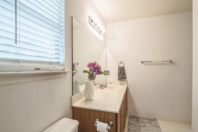 101 Cannery Cv, Leander, TX 78641 - half bathroom with vanity, toilet, and baseboards