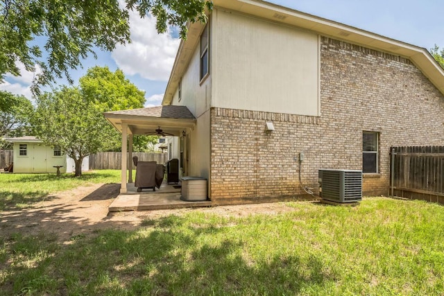 101 Cannery Cv, Leander, TX 78641 - rear view of house with central AC unit, brick siding, a ceiling fan, and a patio area