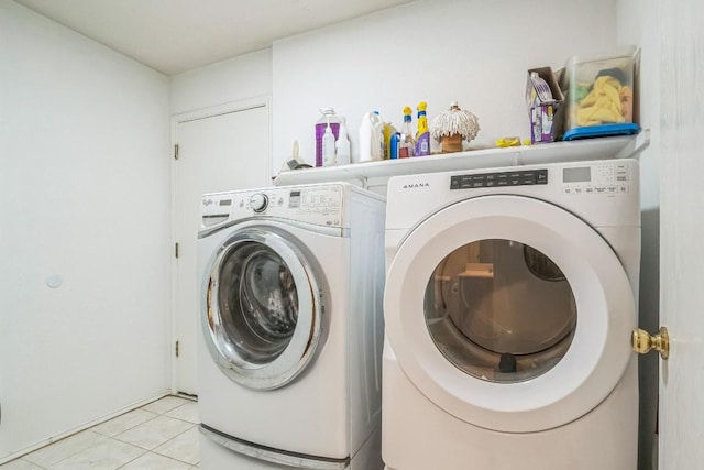 101 Cannery Cv, Leander, TX 78641 - laundry area with washing machine and dryer and light tile patterned floors