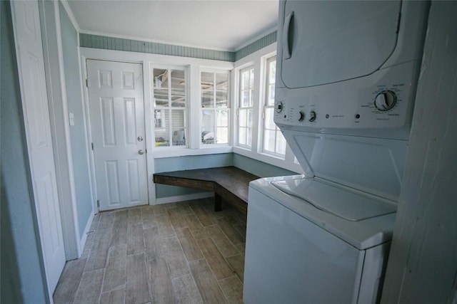 793 N Houston Ave, New Braunfels, TX 78130 - laundry area with stacked washer / drying machine, wood finished floors, baseboards, and ornamental molding