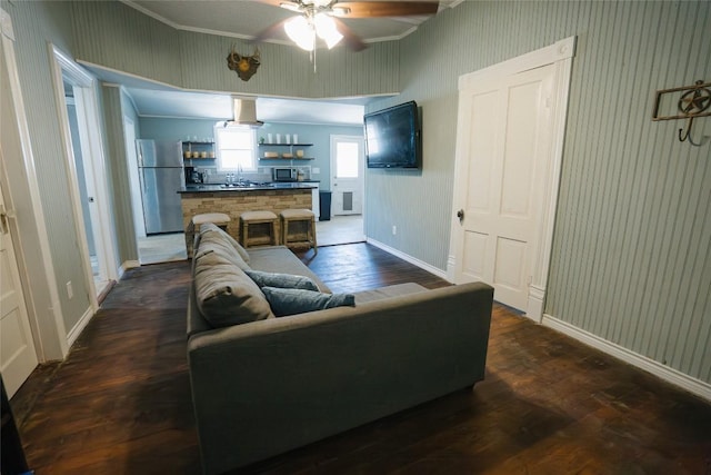 793 N Houston Ave, New Braunfels, TX 78130 - living room featuring ornamental molding, a ceiling fan, dark wood-type flooring, baseboards, and wallpapered walls