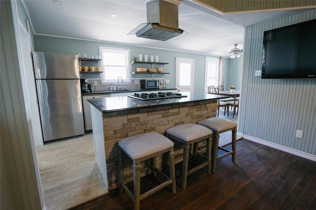 793 N Houston Ave, New Braunfels, TX 78130 - kitchen featuring appliances with stainless steel finishes, open shelves, hardwood / wood-style floors, a sink, and dark countertops