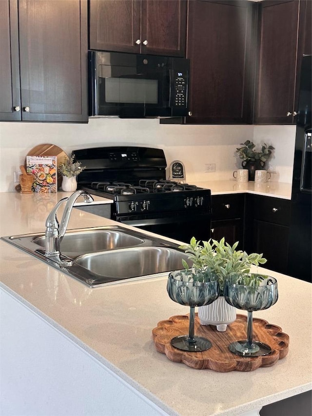 212 Amber Gln, Maxwell, TX 78656 - kitchen featuring black appliances, dark brown cabinets, and a sink