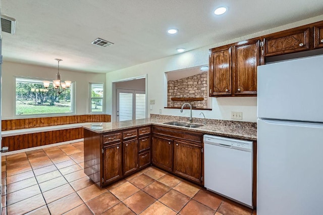 1005 Westland Ridge Rd, Dripping Springs, TX 78620 - kitchen with white appliances, a sink, recessed lighting, a peninsula, and hanging light fixtures