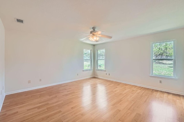 1005 Westland Ridge Rd, Dripping Springs, TX 78620 - empty room featuring plenty of natural light, light wood-style floors, ceiling fan, and baseboards