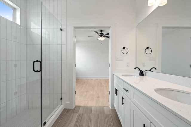 180 Condesa St, Kyle, TX 78640 - bathroom with ceiling fan, double vanity, a stall shower, and baseboards