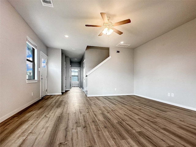 179 Threshing Rd Unit C, Buda, TX 78610 - unfurnished living room with wood finished floors, ceiling fan, baseboards, and recessed lighting