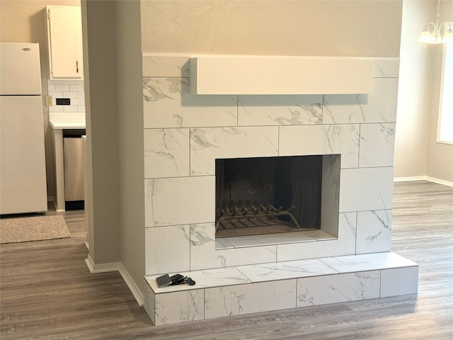 905 Rolling Green Dr, Round Rock, TX 78664 - detailed view of freestanding refrigerator, wood finished floors, dishwasher, and baseboards