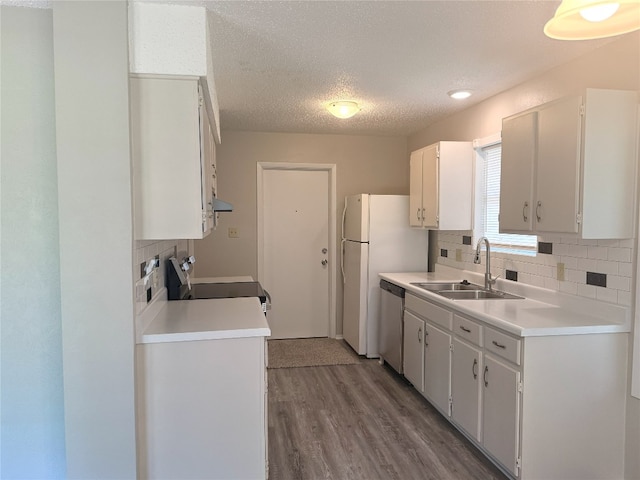 905 Rolling Green Dr, Round Rock, TX 78664 - kitchen featuring range with electric stovetop, stainless steel dishwasher, a sink, decorative backsplash, and wood finished floors