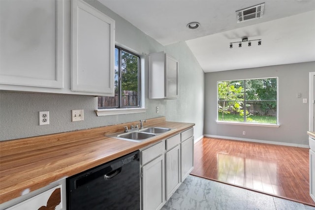 1806 Krizan Ave, Austin, TX 78727 - kitchen featuring dishwasher, a sink, white cabinetry, butcher block counters, and baseboards