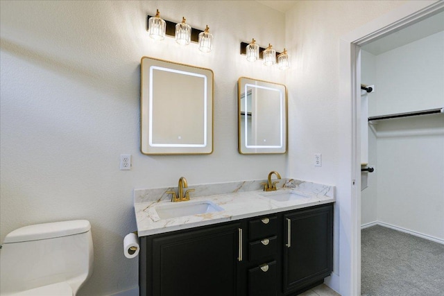 515 Mill Pond Path, Georgetown, TX 78633 - bathroom featuring double vanity, toilet, and baseboards
