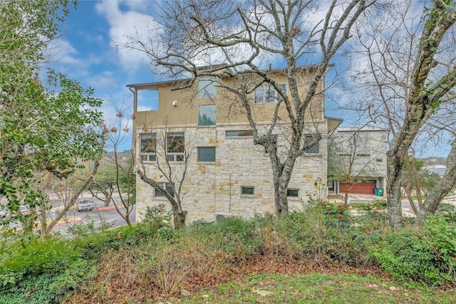 1142 Lost Creek Blvd Unit 12, Austin, TX 78746 - view of property exterior featuring stone siding and stucco siding