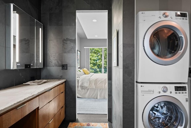 1003 E 8th St, Austin, TX 78702 - washroom featuring tile walls and stacked washing machine and dryer