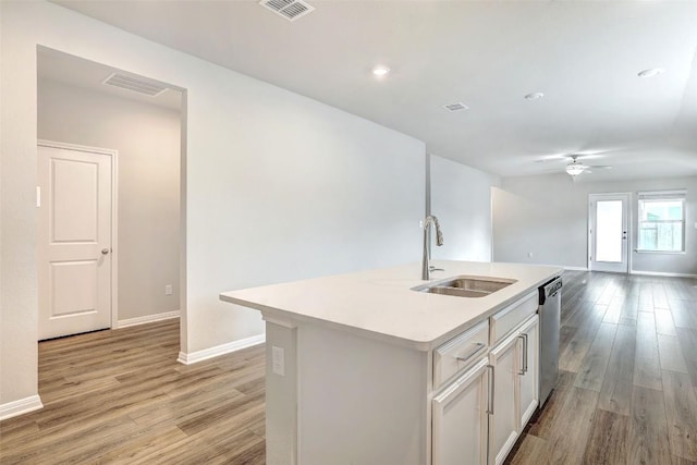 2824 Smokehouse Trl, Round Rock, TX 78665 - kitchen with a sink, light wood-type flooring, a ceiling fan, light countertops, and baseboards