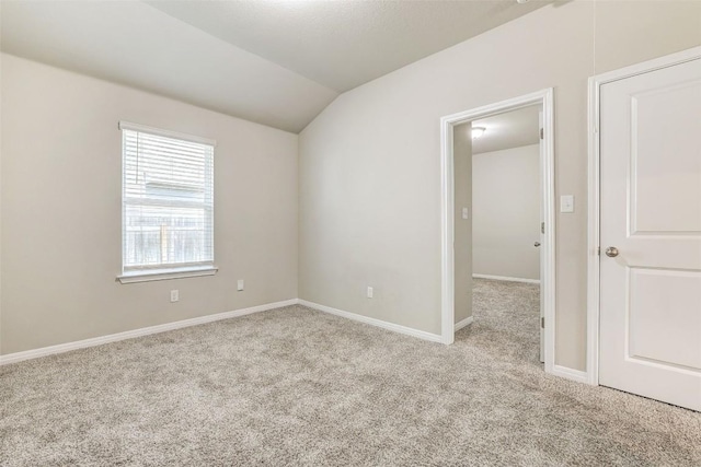 2824 Smokehouse Trl, Round Rock, TX 78665 - spare room with carpet, lofted ceiling, and baseboards