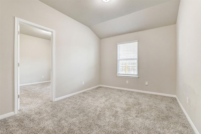 2824 Smokehouse Trl, Round Rock, TX 78665 - carpeted empty room featuring vaulted ceiling and baseboards