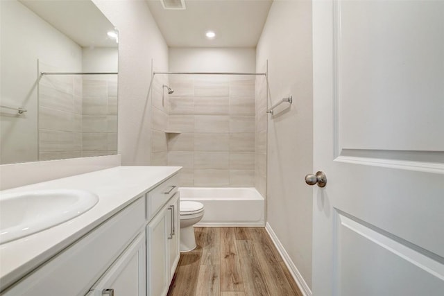 2824 Smokehouse Trl, Round Rock, TX 78665 - bathroom featuring toilet, wood finished floors, vanity, bathing tub / shower combination, and recessed lighting