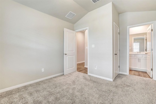 2824 Smokehouse Trl, Round Rock, TX 78665 - unfurnished bedroom featuring carpet flooring, vaulted ceiling, and connected bathroom