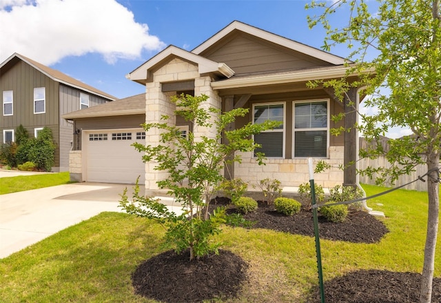 2824 Smokehouse Trl, Round Rock, TX 78665 - view of front of house featuring a garage, driveway, a front lawn, and stone siding