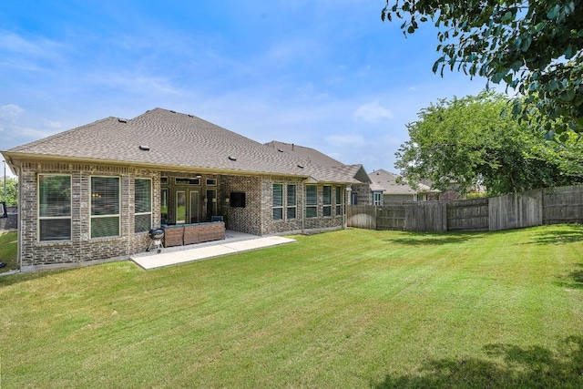 20012 Moorlynch Ave, Pflugerville, TX 78660 - back of property featuring a patio, brick siding, and a shingled roof
