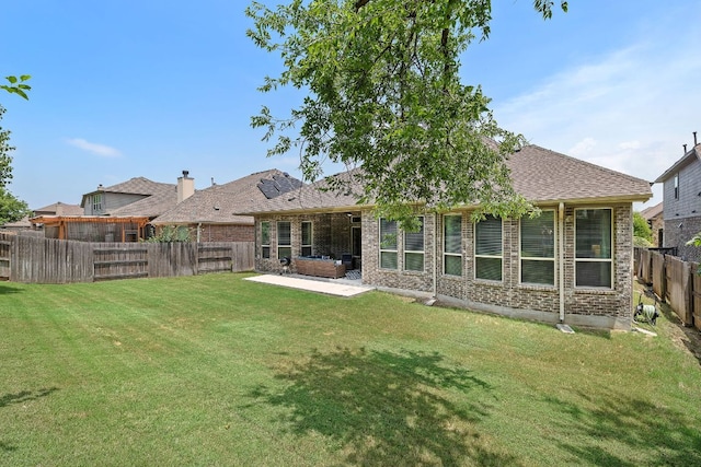 20012 Moorlynch Ave, Pflugerville, TX 78660 - rear view of property with a patio, brick siding, and a fenced backyard