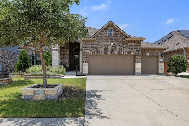 20012 Moorlynch Ave, Pflugerville, TX 78660 - view of front facade featuring a garage, concrete driveway, brick siding, a shingled roof, and stone siding