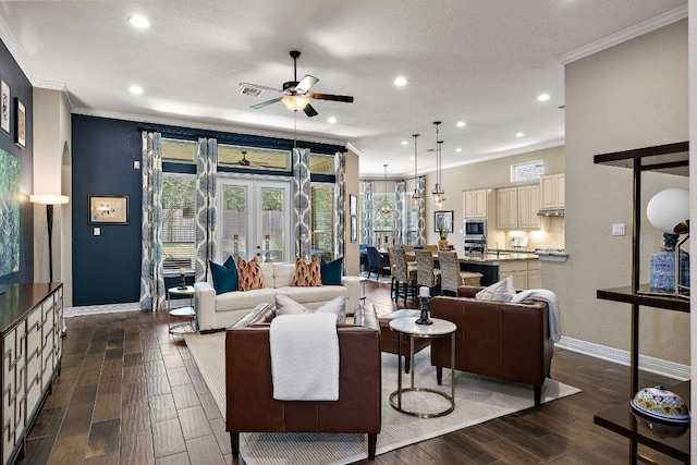 20012 Moorlynch Ave, Pflugerville, TX 78660 - living room featuring crown molding, ceiling fan, dark wood finished floors, and recessed lighting