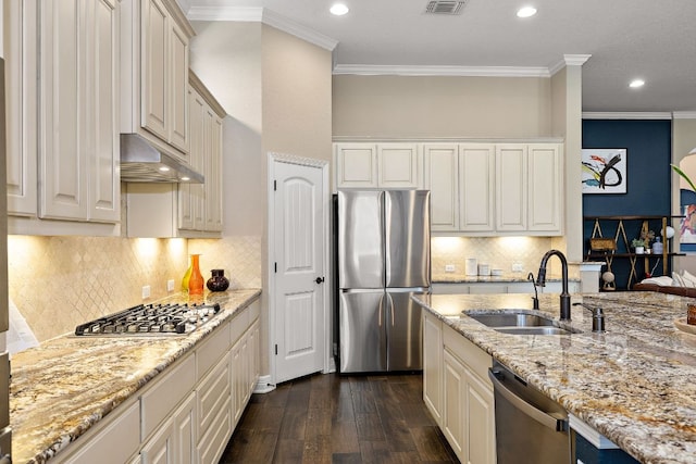 20012 Moorlynch Ave, Pflugerville, TX 78660 - kitchen featuring stainless steel appliances, under cabinet range hood, crown molding, dark wood-type flooring, and recessed lighting