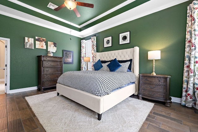 20012 Moorlynch Ave, Pflugerville, TX 78660 - bedroom featuring wood finished floors, a raised ceiling, a ceiling fan, and crown molding