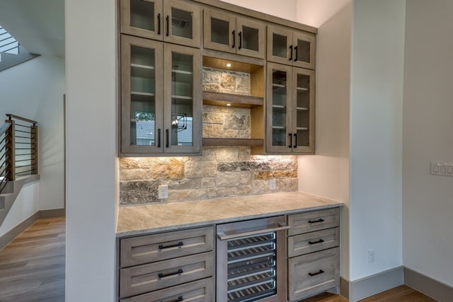 208 E Lakeshore Dr, Sunrise Beach, TX 78643 - indoor dry bar with wine cooler, baseboards, backsplash, and wood finished floors