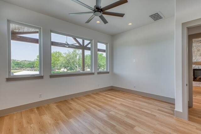 208 E Lakeshore Dr, Sunrise Beach, TX 78643 - spare room featuring a ceiling fan, healthy amount of natural light, light wood-style flooring, and recessed lighting