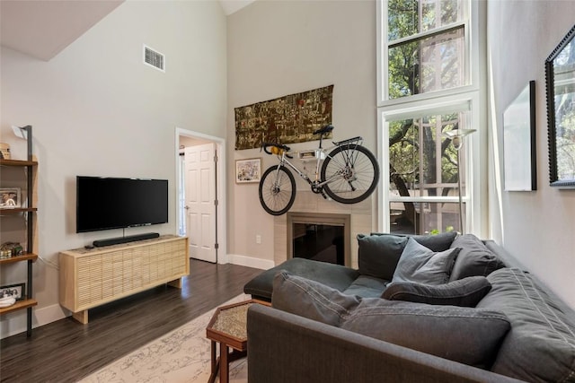 935 La Posada Dr Unit 243, Austin, TX 78752 - living room with high vaulted ceiling, dark wood finished floors, and a tile fireplace